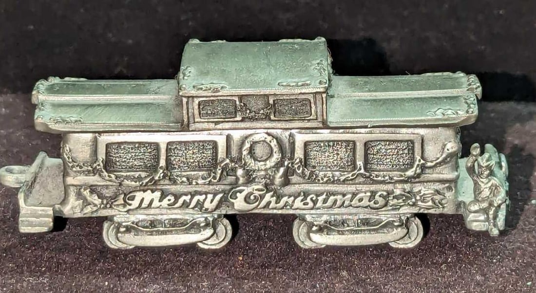 Pewter Santa's Express Merry Christmas Caboose Figurine: Pewter Santa's Express Merry Christmas Caboose Figurine. This is approx 3 1/2" x 1 1/4" x 1 1/2" and it weighs 0.34lb. This was released in 1993. The figurine has light wear.