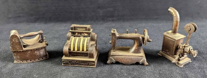 4 Vintage Die Cast Pencil Sharpeners: 4 Vintage Die Cast Pencil Sharpeners. This lot contains: (1) "Play Me" Sewing Machine Pencil Sharpener. This is approx 2 1/2" x 1 1/4" x 2". (1) "Play Me" Old Timey Cash R