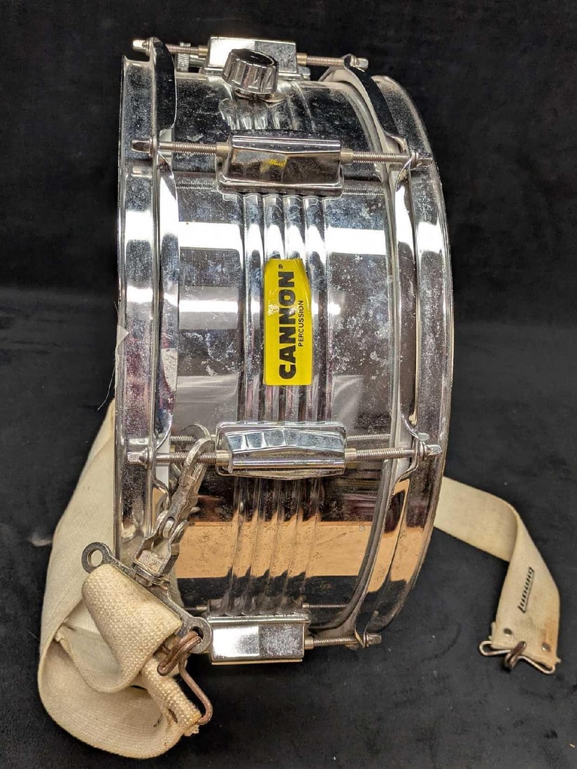 Cannon Chrome Percussion 14" Snare Drum: Cannon Chrome Percussion 14" Snare Drum. This is 6 1/2" x 14 1/2" x 14 1/2" and it weighs 8lbs.There is some wear/color loss on the batter head and some surface rust on the metal along with some scrat
