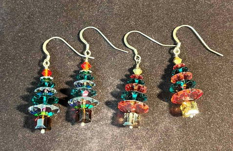 Two Pairs Of Sterling Silver Swarovski Christmas Tree Earrings (5): This lot contains Two Pairs Of Sterling Silver Swarovski Christmas Tree Earrings (5). Marked 925. The earrings are one size fits all. Together they weigh about 0.4oz. Overall the earrings are in excel