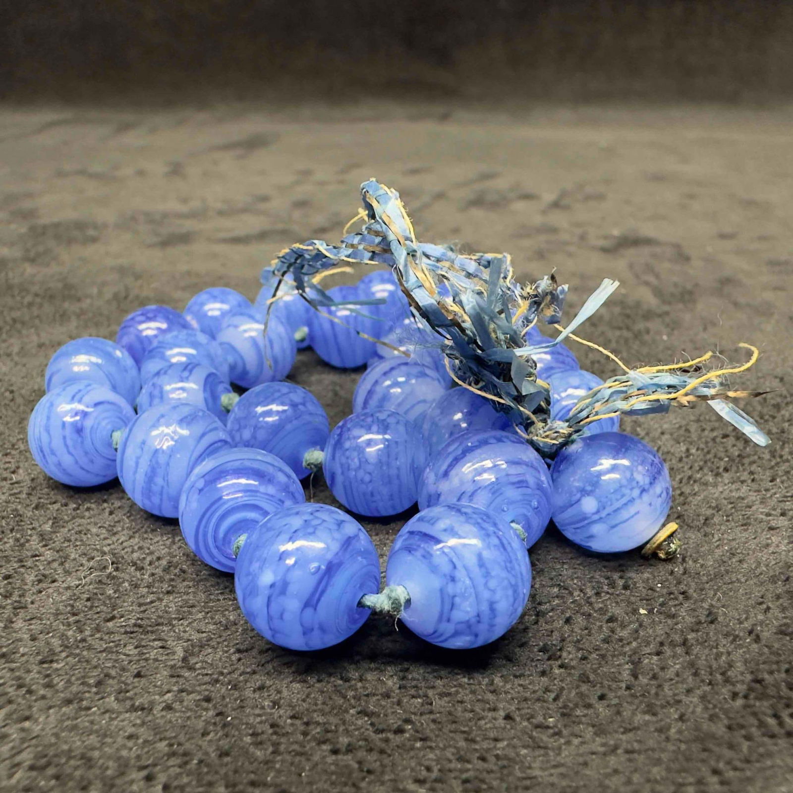 Murano Venetian Lamp Work Art Glass Blue Swirl Beaded Necklace Broken H15: Murano Venetian Lamp Work Art Glass Blue Swirl Beaded Necklace Broken H15. Necklace with multiple shades of blue colored glass beads with beautiful designs on each. The necklace is broken loose on bot