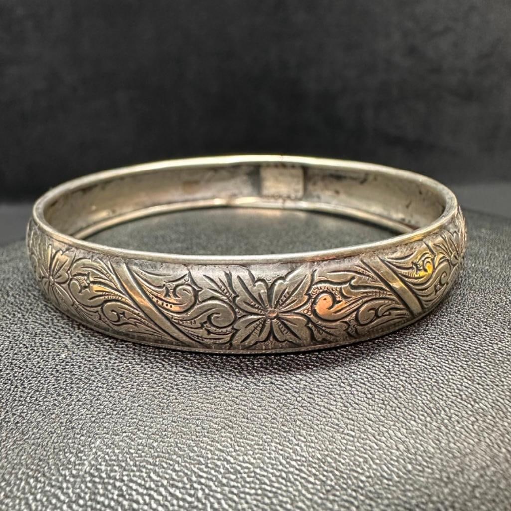 Beau Sterling Floral Engraved Bangle: This piece of jewelry has been tested and researched prior to listing. Please view all our pictures they are part of our description. DETAILS: Metal - Sterling Silver Color - Silver Stones - none Hal