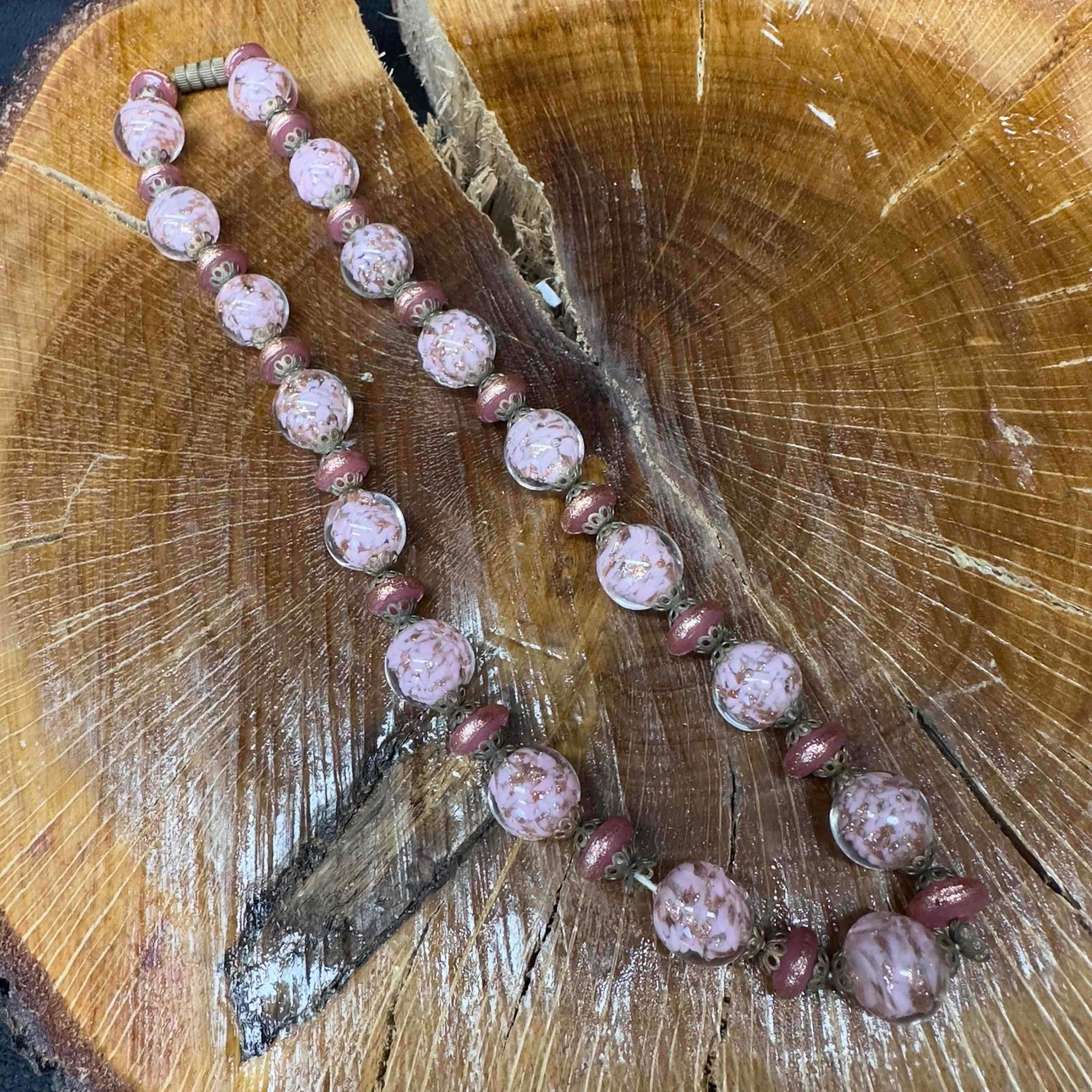 Venetian Murano Lamp Work Glass Pink Bead Copper Accent Necklace A36: Venetian Murano Lamp Work Glass Pink Bead Copper Accent Necklace A36. Necklace with green colored glass beads with beautiful designs on each. The necklace features copper colored accents. The necklace