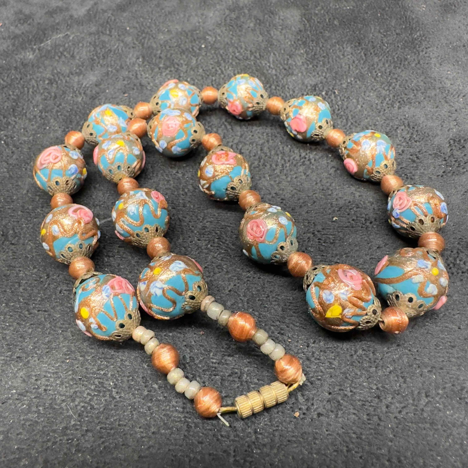 Murano Venetian Glass Lamp Work Blue Bead Fiorato Beaded Pink Floral Necklace A60: Murano Venetian Lamp Work Glass Blue Bead Fiorato Beaded Pink Floral Necklace A60. Necklace with blue colored glass beads with beautiful hand painted designs on each. The necklace features floral pink