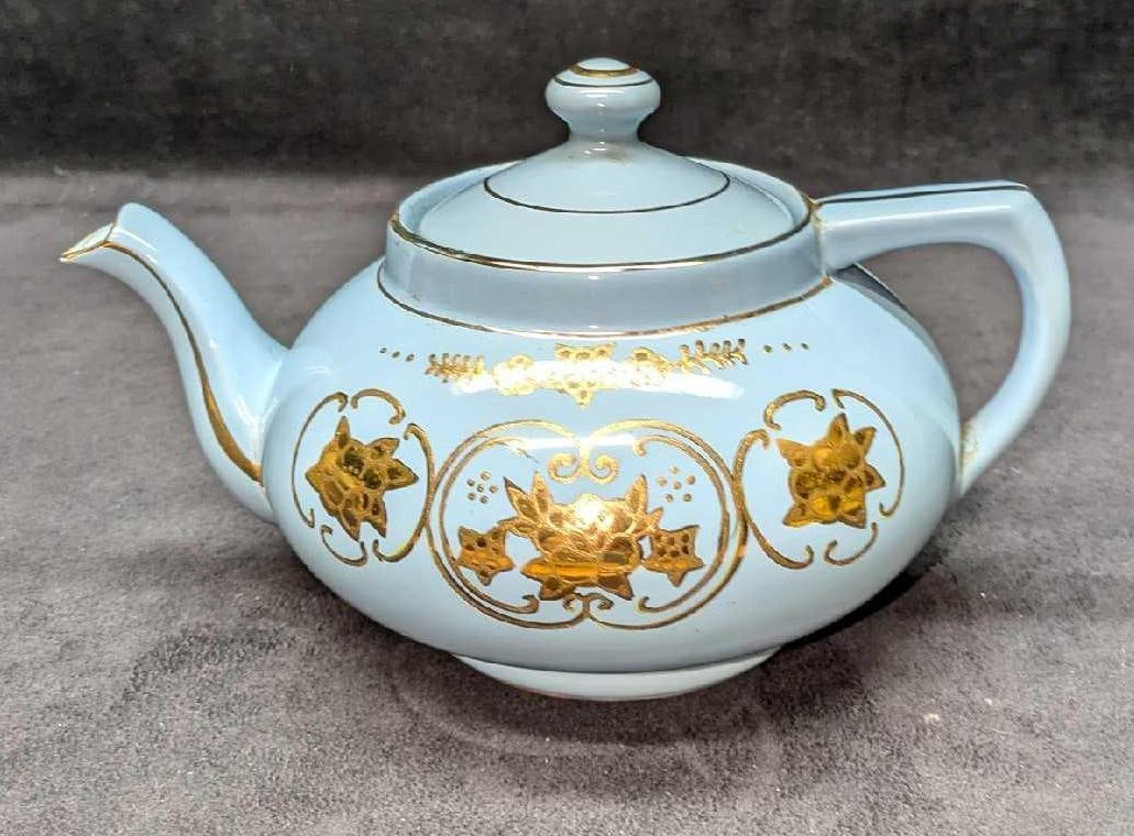 Vintage Converted Porcelain Teapot Music Box: Vintage Converted Porcelain Teapot Music Box. This is approx 9 1/2" x 7" x 6" and it weighs 2.17lbs. The music box works, but the sound is a little off and we could not figure out what song it was pla