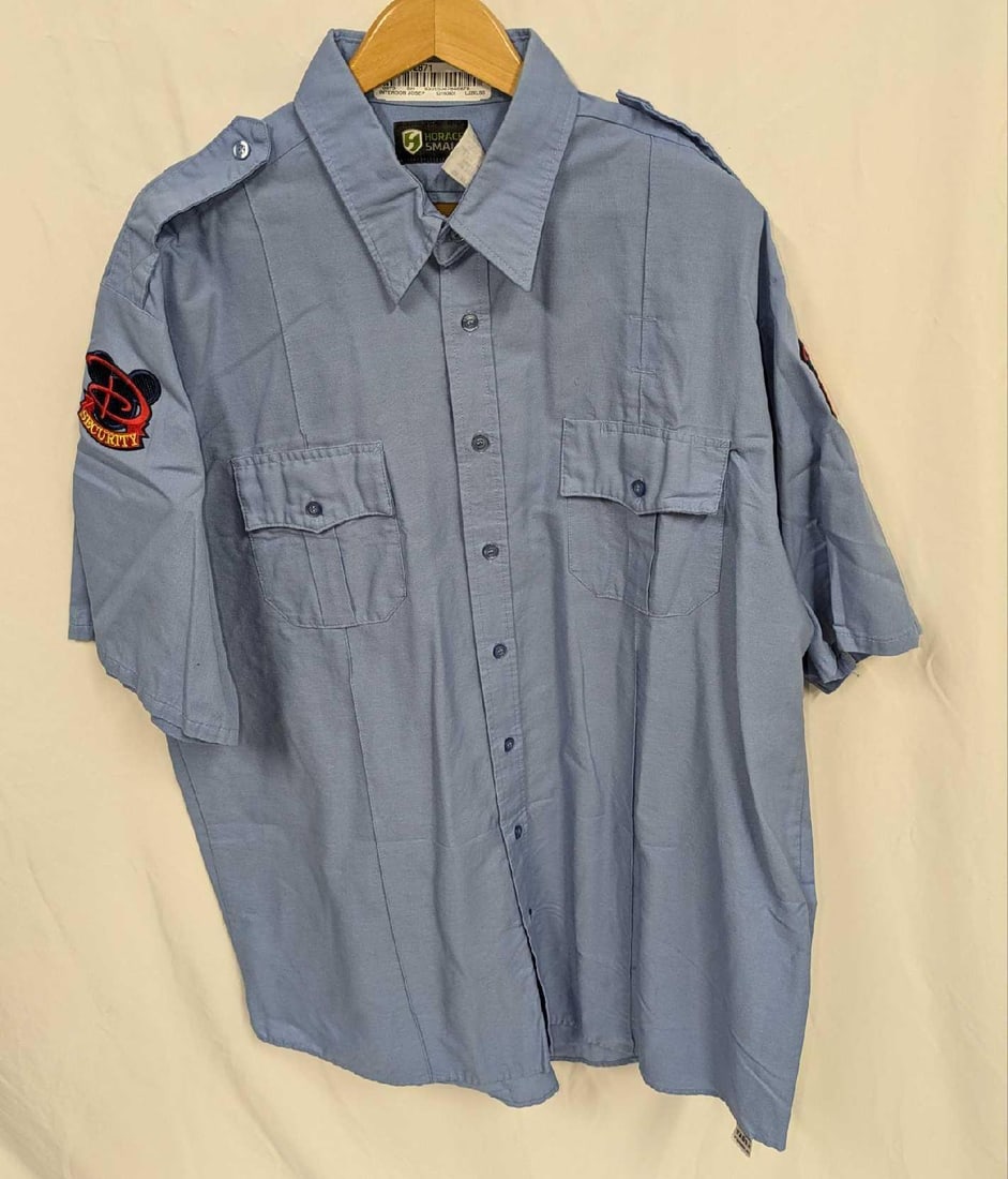 Disney World Security Cast Member Uniform Shirt XXL Short sleeve C: Disney World Security Cast Member Uniform Shirt XXL Short sleeve B. This does not appear to have been worn. The shirt has wrinkles from storage and it does not come with the hanger shown in the images