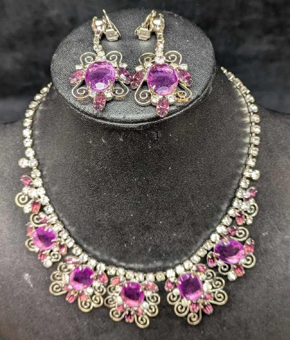 Silvertone Rhinestone And Simulated Amethyst Necklace And Earrings: Silvertone Rhinestone And Simulated Amethyst Necklace And Earrings. The maker and date of creation is unknown. The choker necklace is approx 1 1/2" x 16" x 1/4" and the clip on on earrings are approx 