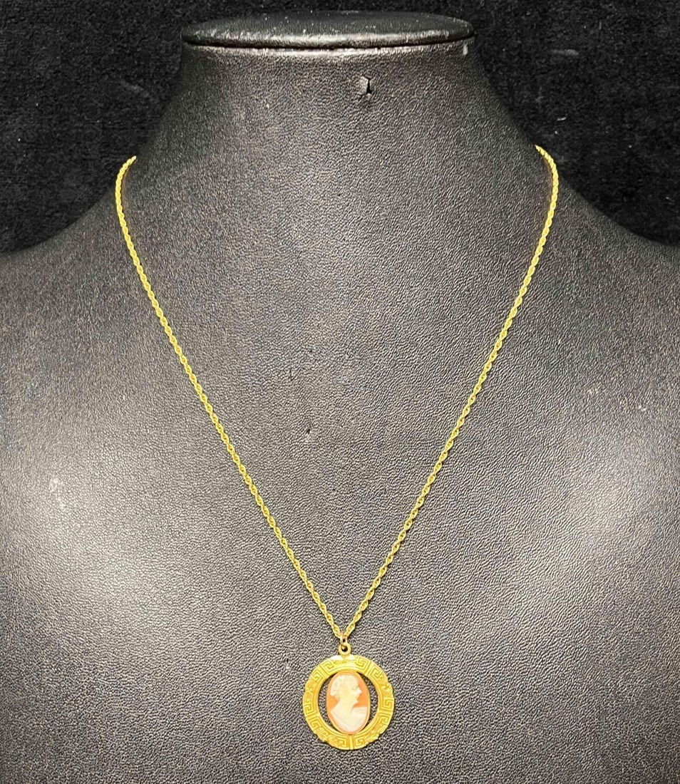 1/20 12kt Gold Filled Cameo Pendant Necklace: This lot contains a 1/20 12kt Gold Filled Cameo Pendant Necklace. The pendant is approx 1" x 3/4" while the chain is 9" long when clasped. Total weight is approx less than 1 gram. Overall the necklace