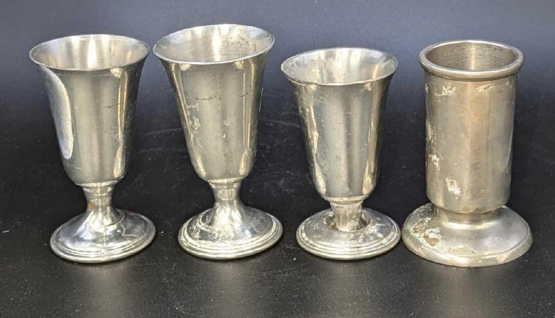 4 Vintage Pewter Silver Tone Candlestick Holders: 4 Vintage Pewter Silver Tone Candlestick Holders. The bell shaped holders are approx 1 1/2" x 1 1/2" x 2 3/4", 1 5/8" x 1 5/8" x 3", and 1 5/8" x 1 5/8"x 3 1/8". The other is approx 1 1/8' x 1 1/8" x