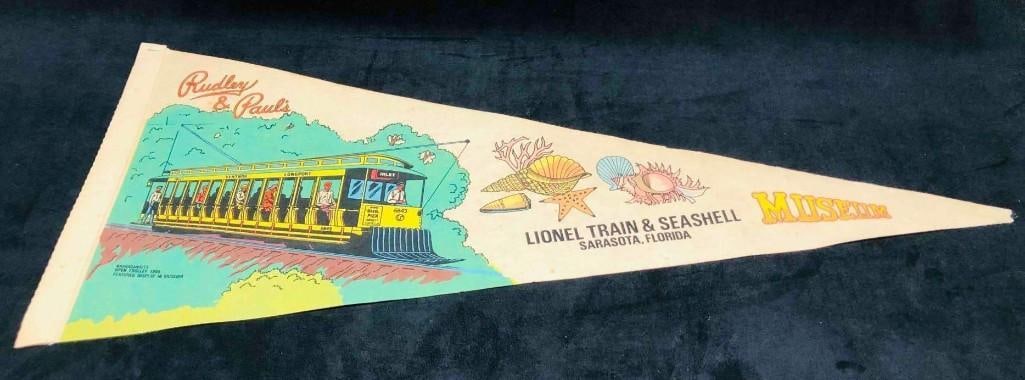 Lionel Train & Seashell Sarasota Florida Museum Pennant Flag: Lionel Train & Seashell Sarasota Florida Museum Pennant Flag. This lot contains a Lionel Train & Seashell Sarasota Florida Museum Flag. It is approx 11 3/4" x 29 1/2" and it weighs about 0.06lbs.