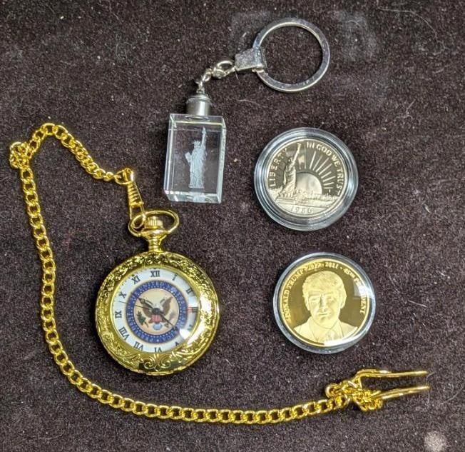 Trump Statue Of Liberty & Keychain & Pocket Watch: Trump Statue Of Liberty & Keychain & Pocket Watch. This lot includes: (1) 1986 50 Cent Coin - Statue Of Liberty. This is 30.6mm and was sealed in an acrylic case. Made of copper and nickle. F