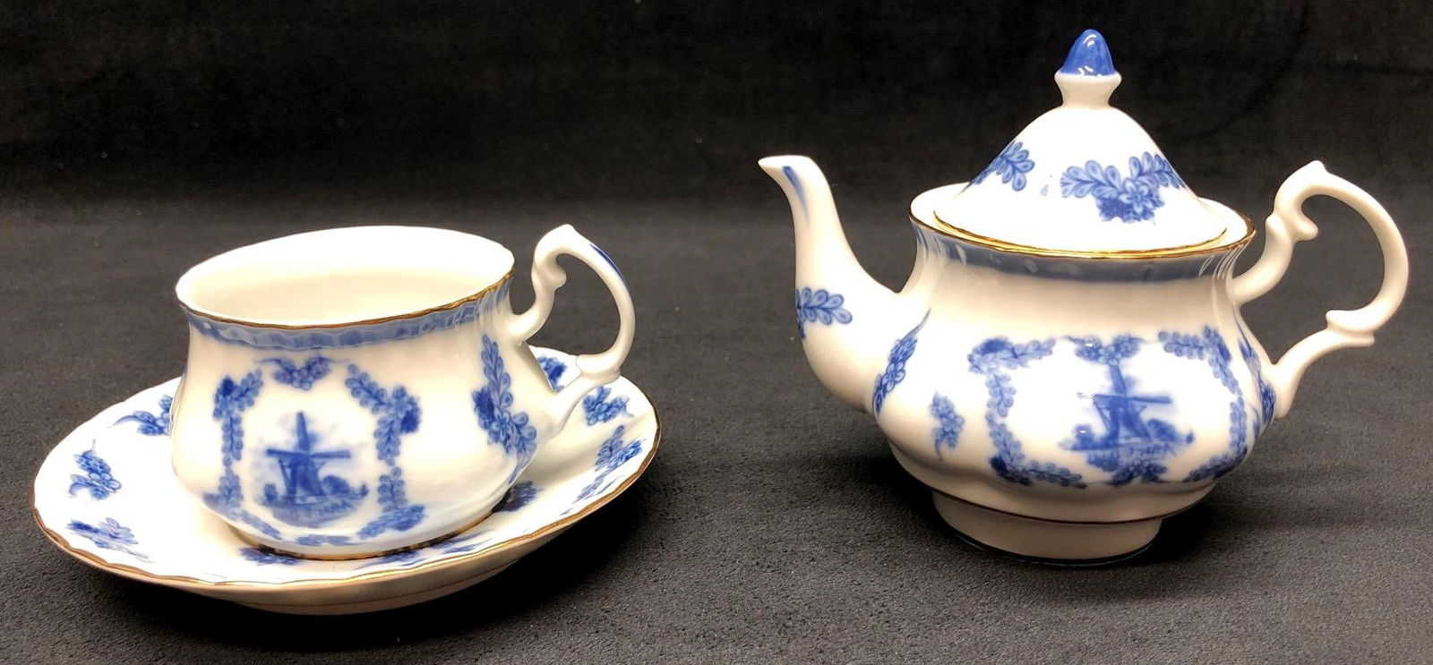 D.N. & E.I - 3pc Delft Set - Blue & White Porcelain Tea Pot, Tea Cup & Saucer - Dutch Windmill: 3pc Set of Delft Porcelain - Tea Pot, Tea Cup and Saucer - D.N. & E.I. - Blue & White - Dutch Windmills. Tea Pot 6-3/4" x 4-1/2" x 4" Tea Cup 4-1/2" x 4" x 2-3/4" Sau