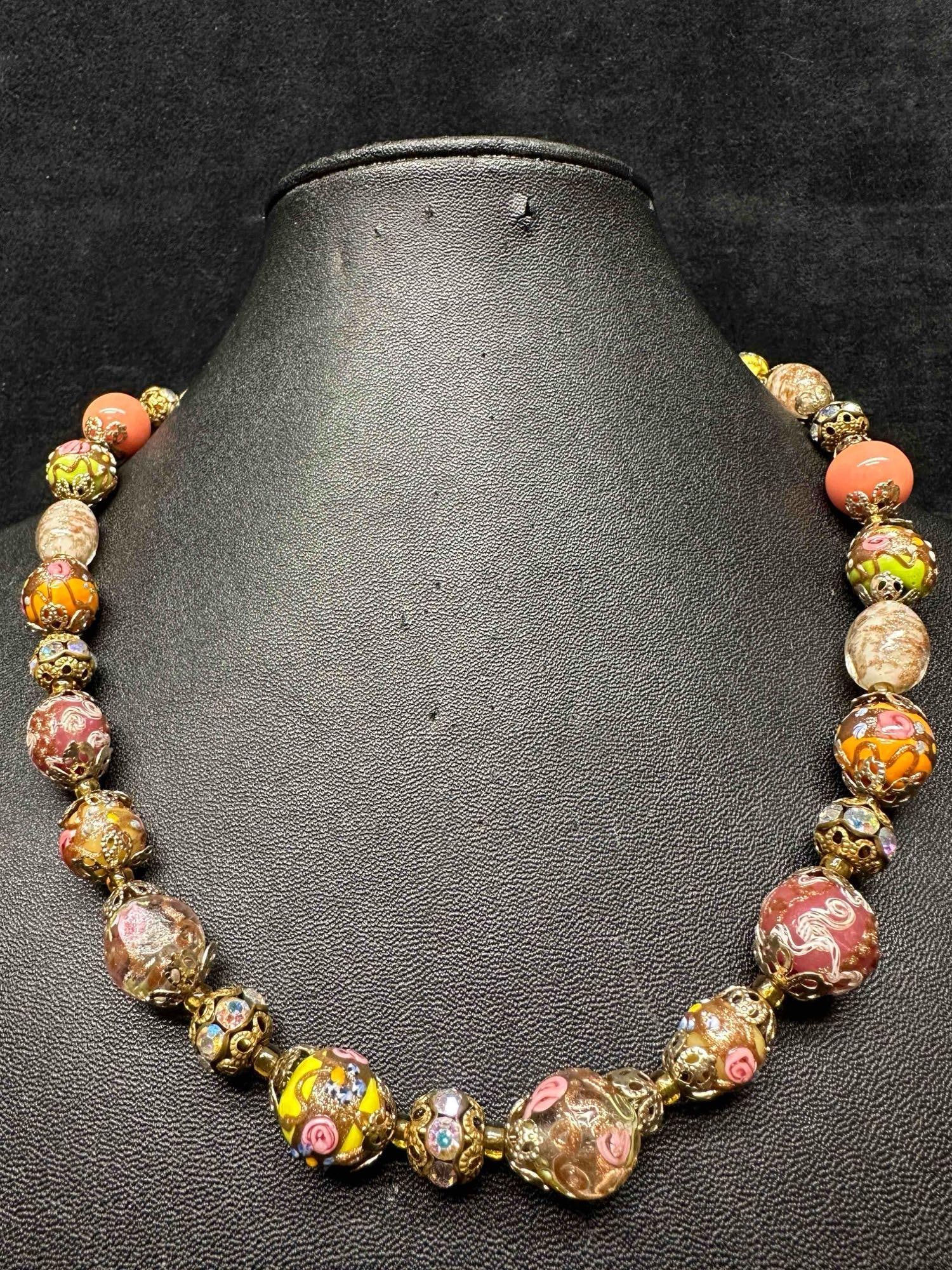 Murano Venetian Lamp Work Art Glass Multi Color Copper Floral Accents Beaded Necklace F6: Murano Venetian Lamp Work Art Glass Multi Color Copper Floral Accents Beaded Necklace F6. Necklace with multi colored glass beads with a beautiful design on each. The necklace features floral and copp