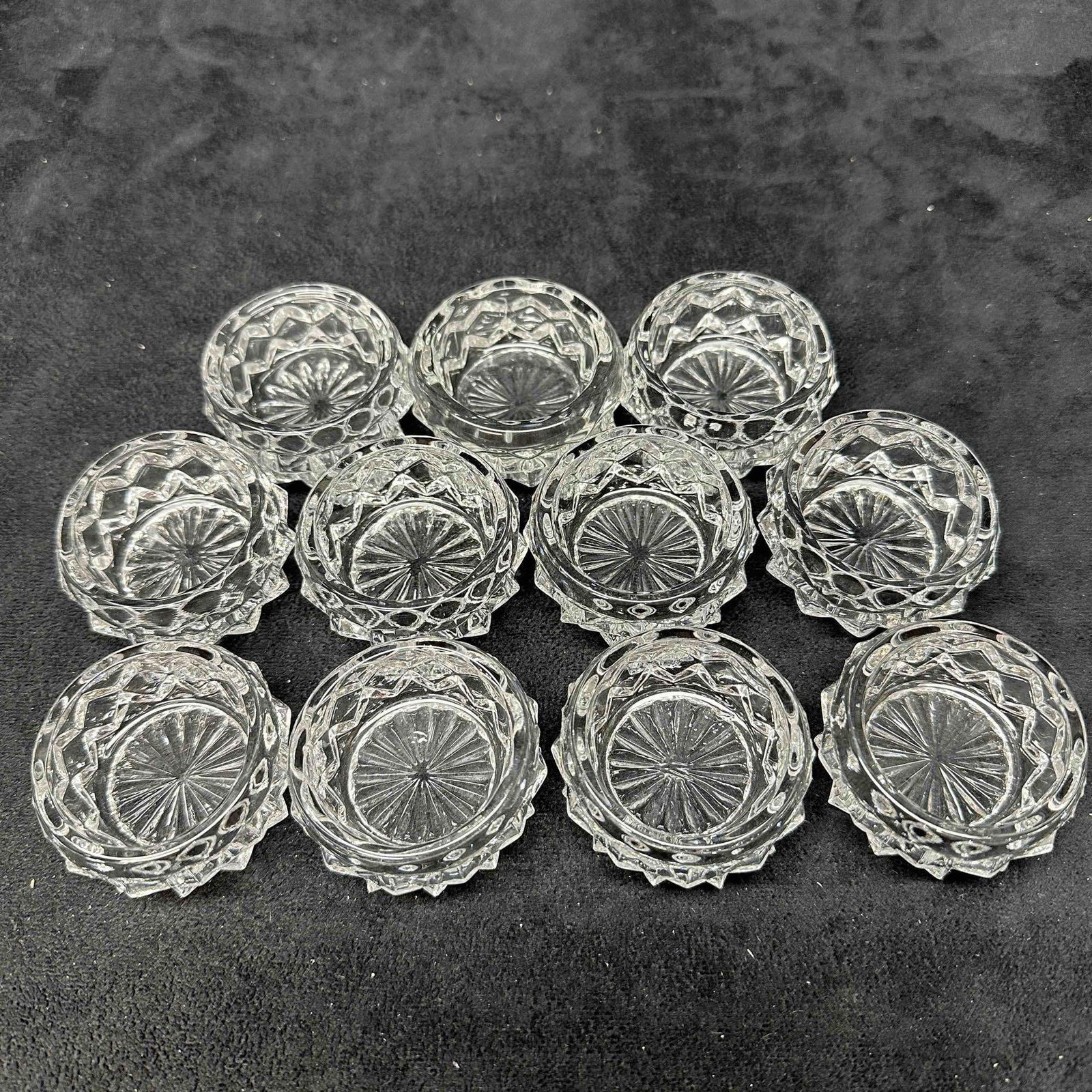 Fostoria American Clear Cut Glass Salt Cellar Set Eleven Round Vessels: Eleven glass salt cellar spice holder set. A few noticeable scratches on a few of the glass vessels. No noticeable chips, cracks, or breaks in the glass pieces. These items are in good pre-owned, prev
