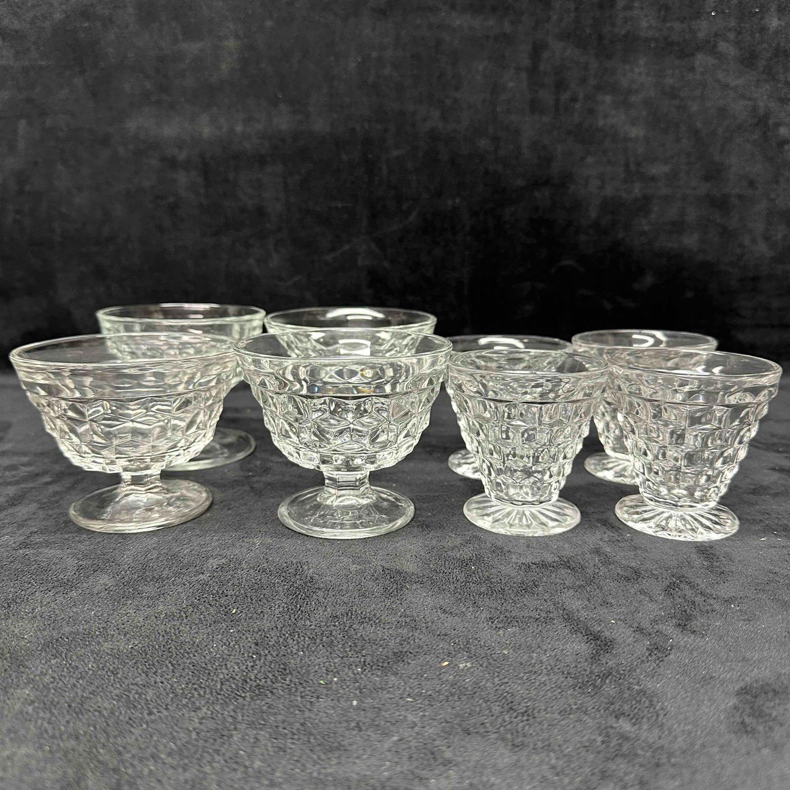 Fostoria American Clear Glass Oyster Cocktail Glasses and Sundae Dishes Set: Eight Fostoria glass pieces included in this set, including four sundae dishes and four oyster cocktail glasses. One small minor chip on one of the smaller glass pieces. No other chips, cracks, or bre