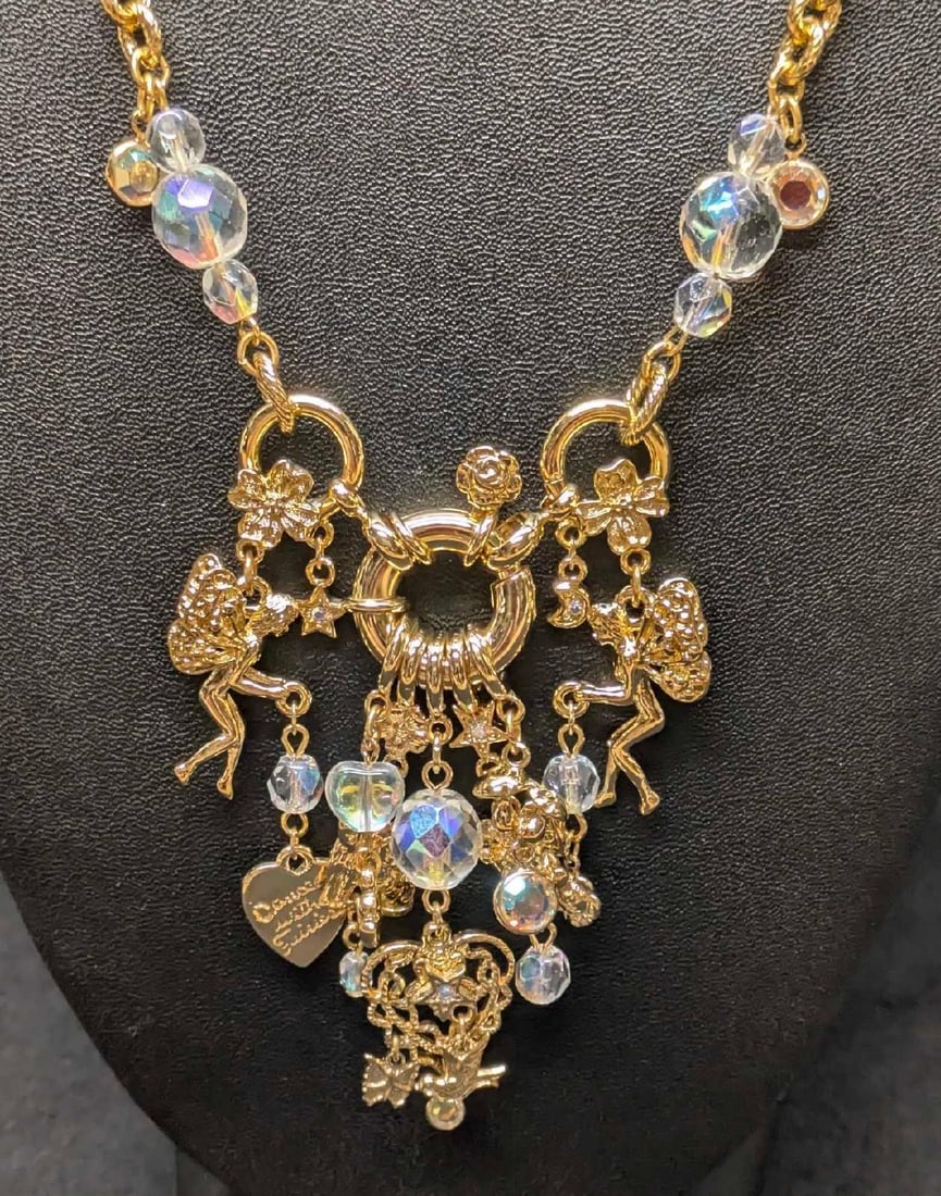 Vintage Kirks Folly Cherub Fairy Gold Tone Charms And Necklace: Vintage Kirks Folly Cherub Fairy Gold Tone Charms And Necklace. Long gold tone chain with hanging cherub and fairy charms and beads. The chain is approx 25" and the pendant is approx 3 1/2" x 2" x 1/2
