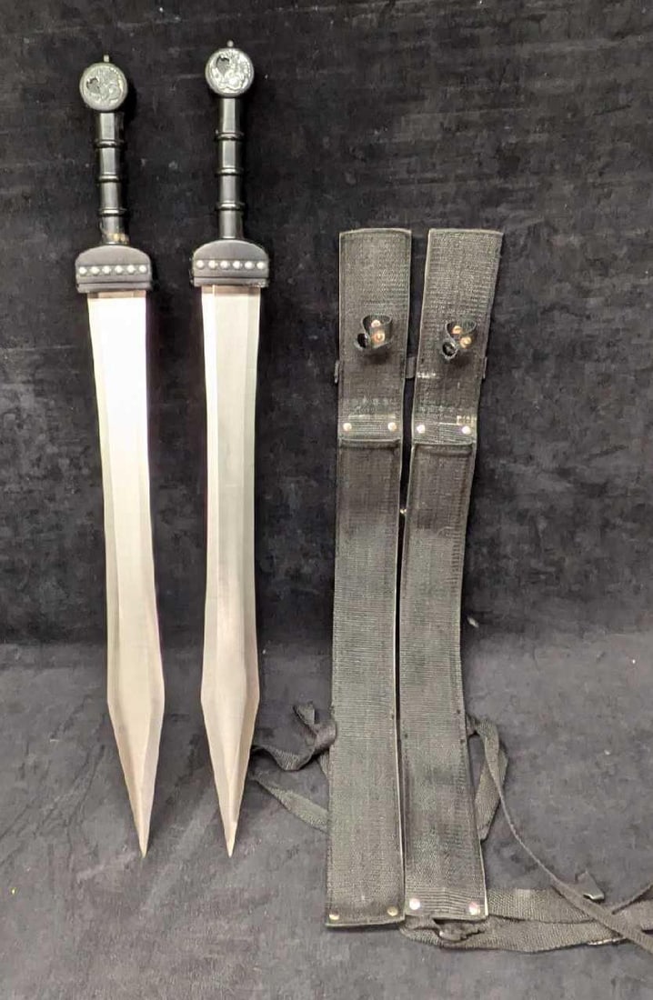 Dual Dragon Hilt Metal Swords With Nylon Scabbards: Dual Dragon Hilt Metal Swords With Nylon Scabbards. Each is approx 2 3/4" x 1 1/2" x 26" and the total weight is 3lbs. The dragon hilts appear to be missing something. There is some light surface rust