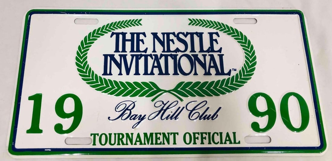 The Nestle Invitational Bay Hill Club Tournament Official 1990 License Plate: This lot contains a The Nestle Invitational Bay Hill Club Tournament Official 1990 License Plate. It is approx 6 1/4" x 11 3/4" and it weighs about 0.1lbs. Overall the License Plate is in good used co