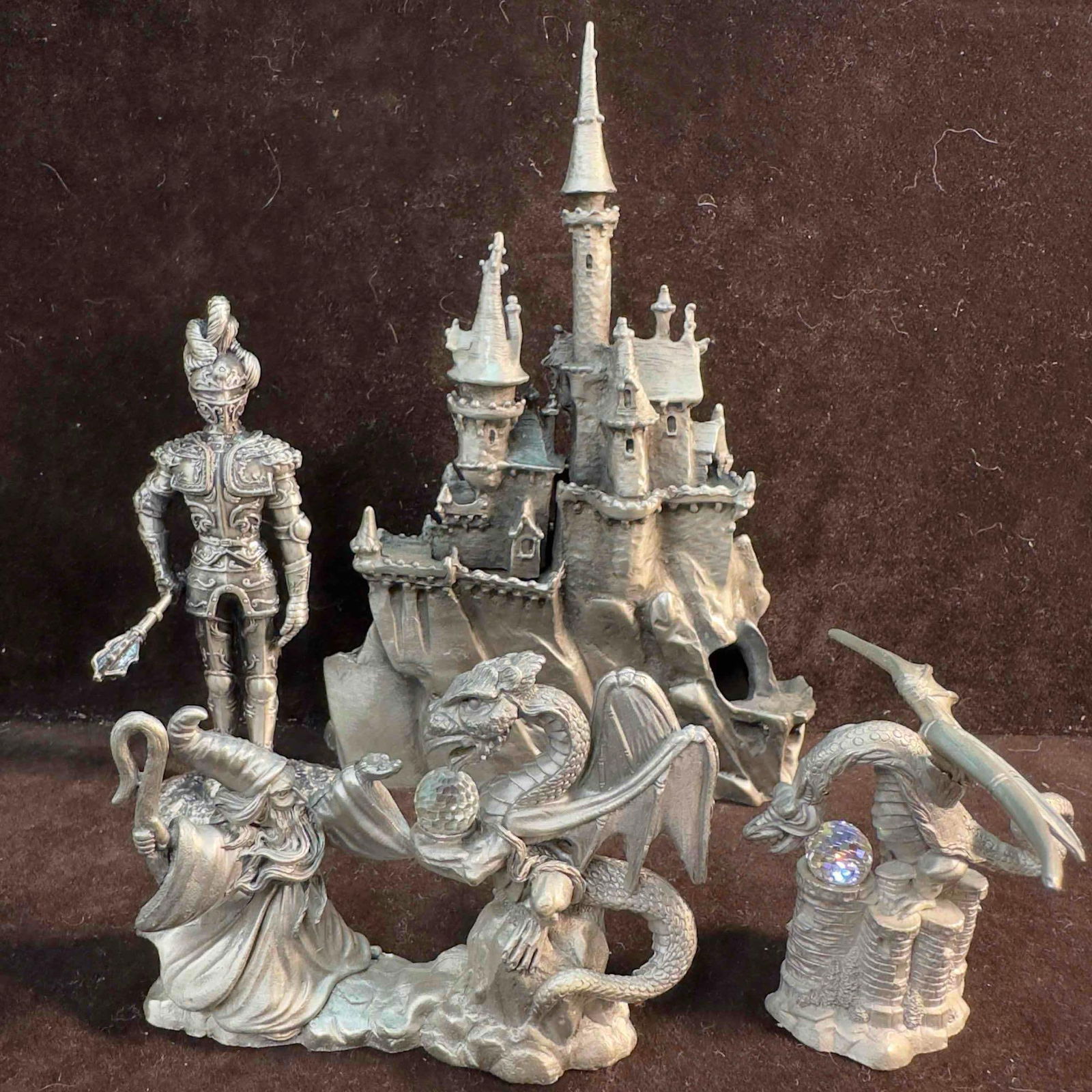 Pewter Castle Royal Knight Wizard Sorcerer and Dragon Mini Fantasy Sculpture Figurines Set Lot of 4: Pewter Castle Royal Knight Wizard Sorcerer and Dragon Mini Sculpture Figurines Set. This set includes four pewter figures featuring dragons, a wizard, a castle, and a knight. Identifying markings etch