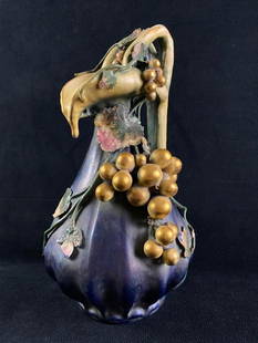 Turn of the Century Edda Amphora Pitcher JB: Turn of the Century Edda Amphora Pitcher Beautiful Art-Nouveau Italian porcelain pitcher, with an iridescent purple glaze and 3-D gilded grapes and painted leaves. The pitcher dates to between 1897 a