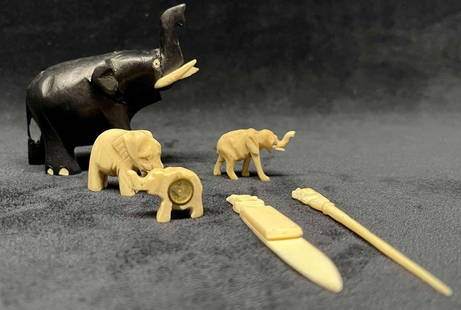 Unique Hand Carved Bone Elephant Bundle: This lot contains a Unique Hand Carved Bone Elephant Bundle. The bundle includes one wooden elephant with bone tusks and toes, two carved bone elephant figurines, two picks with carved out elephants a