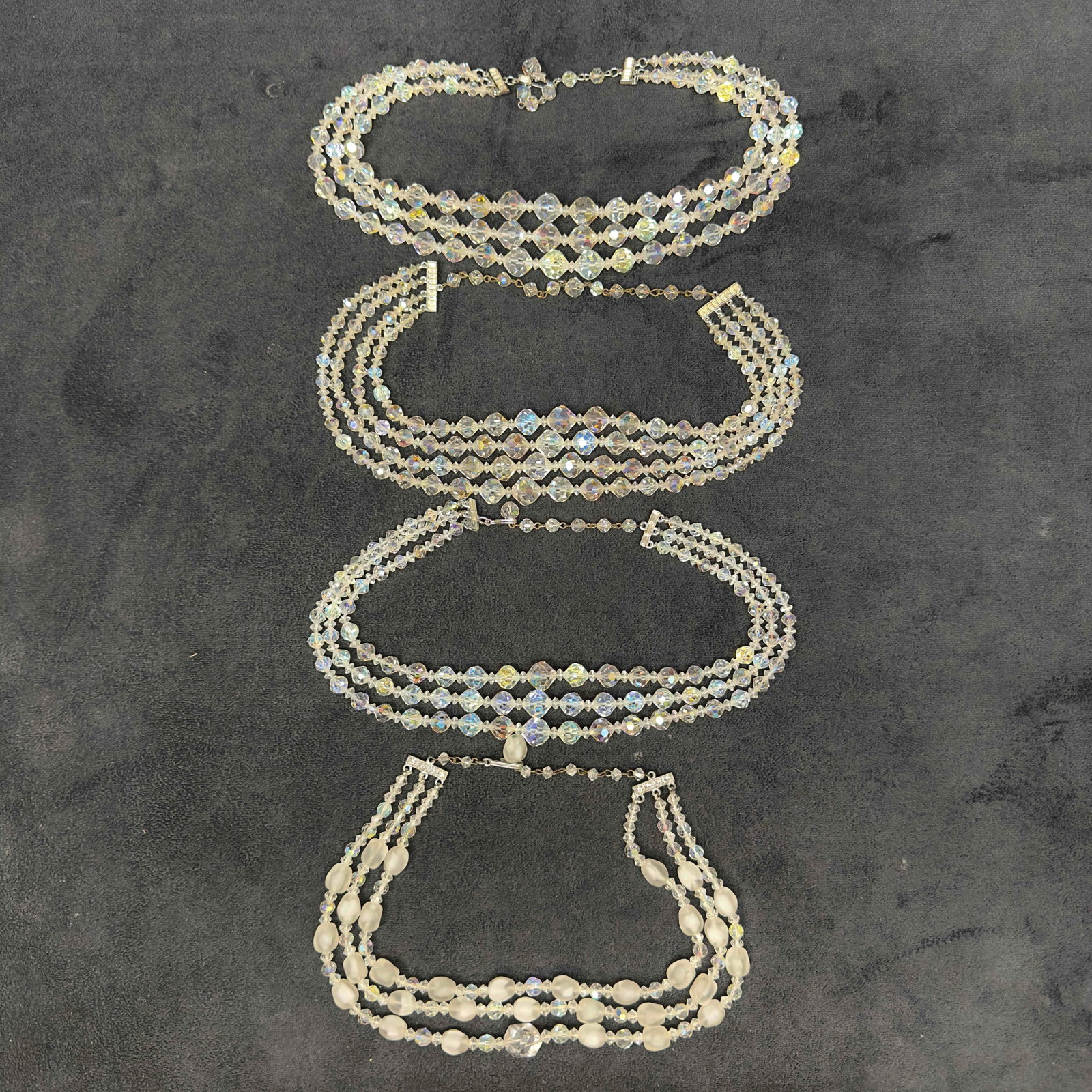 Costume Jewelry Clear Glass Crystal Necklace Set Lot of Four H64: Costume Jewelry Clear Glass Crystal Necklace Set Lot of Four H64. Necklaces with clear crystal glass beads with beautiful designs. Each necklace features a j hook clasp closure. One necklace the clasp