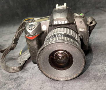Nikon D70S 6.1MP Digital SLR Camera With Case And Extras: Nikon D70S 6.1MP Digital SLR Camera With Case And Extras. The camera (untested) comes with an extra lens (Nikon DX VR 18-55mm, a Nikon Speedlight SB-910 and Speedlight&nbsp;SB-600, legacy media card r