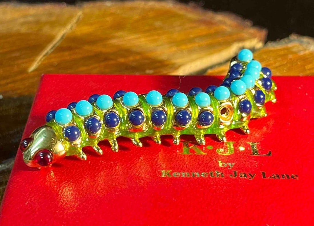 KJL Kenneth Jay Gold Tone Caterpillar Brooch: This lot contains a KJL Kenneth Jay Gold Tone Caterpillar Brooch In Box. The box is approx 3 3/4" x 4 1/2" x 1 1/4". Total weight is approx 2oz. Overall the KJL Brooch is in good used condition with s