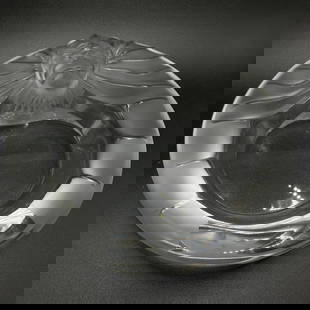 Lalique Tete de Leo Ashtray: Lalique Tete de Leon Ashtray  Tete de Leon ashtray by Lalique, in clear crystal with their signature frosted texture. The ashtray stands approximately 2&#34; tall, 5.75&#34; in diameter, and weighs ap