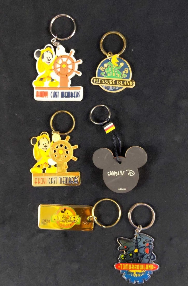 6 Vintage And Cast Exclusive Disney Keychains: This lot includes: (1) Disney Cast Exclusive Mickey Foam Mickey Keychain. Is approx 2 1/2" x 4". (1) Disney Cast Exclusive Ahoy Cast Members Mickey (Rubber) Keychain. Is approx 3" x 5"