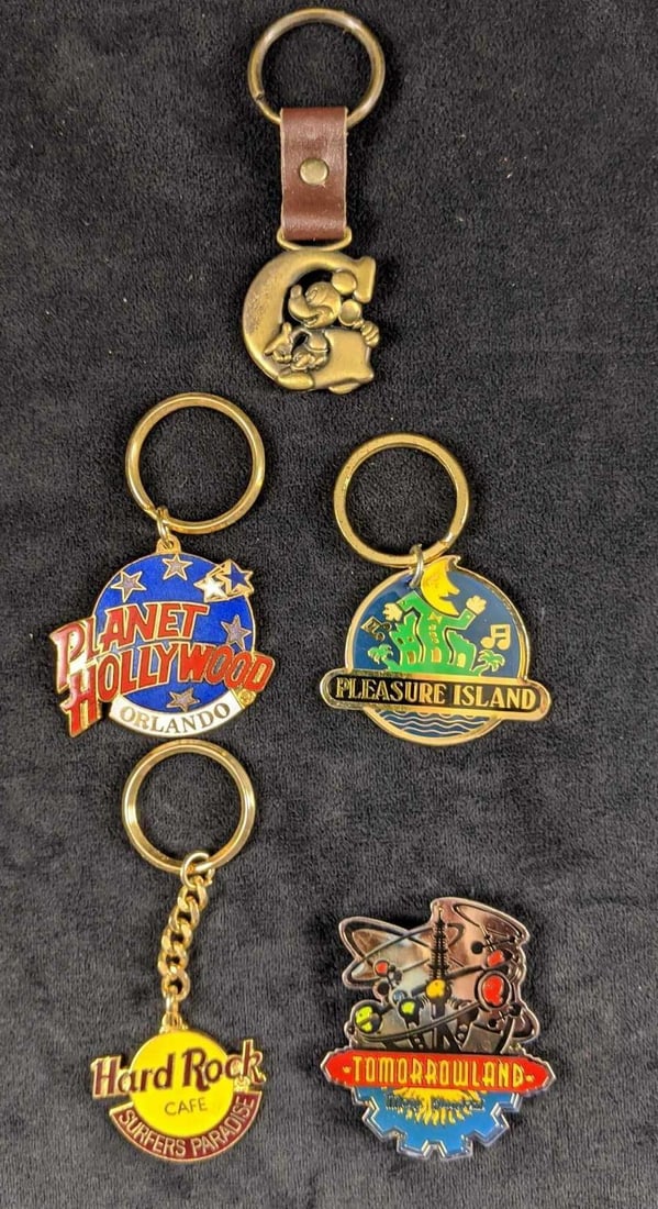 Disney Lot Of Four Keychains And One Magnet Pleasure Island: This lot includes: One Pleasure Island keychain. One Hard Rock Cafe: Surfer's Paradise keychain. One Planet Hollywood Orlando keychain One Disney "G" pewter like keychain One Magic Kingd