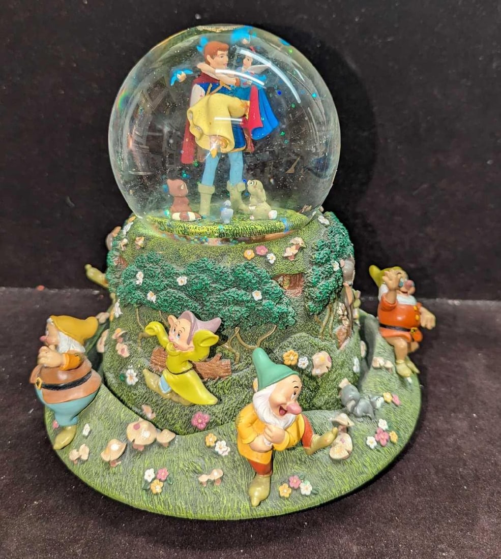 Disney Snow White Happily Ever After Snowglobe: Disney Snow White Happily Ever After Snowglobe. Plays "Someday My Price Will Come". As the music plays, the outer slowly spins. This is approx 8" x 8" x 8" and it weighs 4.20lbs. The light feature doe