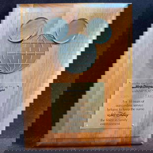 Walt Disney World 10 Year Service Award Cast Member Plaque Mickey Mouse: Walt Disney World 10 Year Service Award Cast Member Plaque Mickey Mouse. Disney wooden service award plaque with bronze accents celebrating a cast member Disney employees ten years of service at Walt