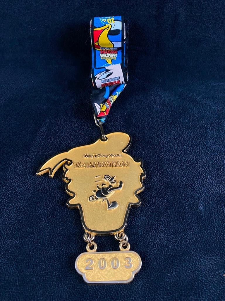 2003 Disney Half Marathon Medal Donald Duck JB: 2003 Disney Half Marathon Medal Donald Duck Donald Duck shaped medal from a participant in the Disney 1/2 Marathon at Walt Disney World in 2003. The medal has some light wear, but is in good condition