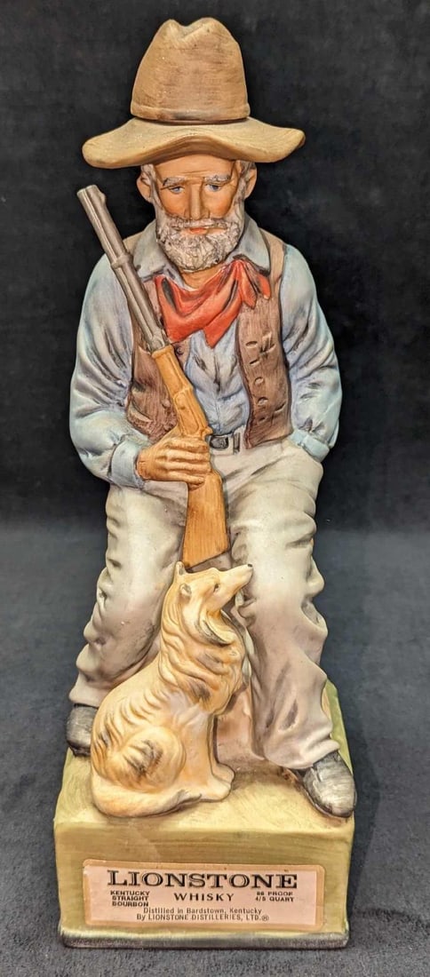 1969 Camp Cook Porcelain Lionstone Decanter: 1969 Camp Cook Porcelain Lionstone Decanter. Made of porcelain. This limited edition decanter is approximately 4 1/4" x 4 1/2" x 12 1/2" and it weighs 3.63 lbs. The front and back labels have some wea