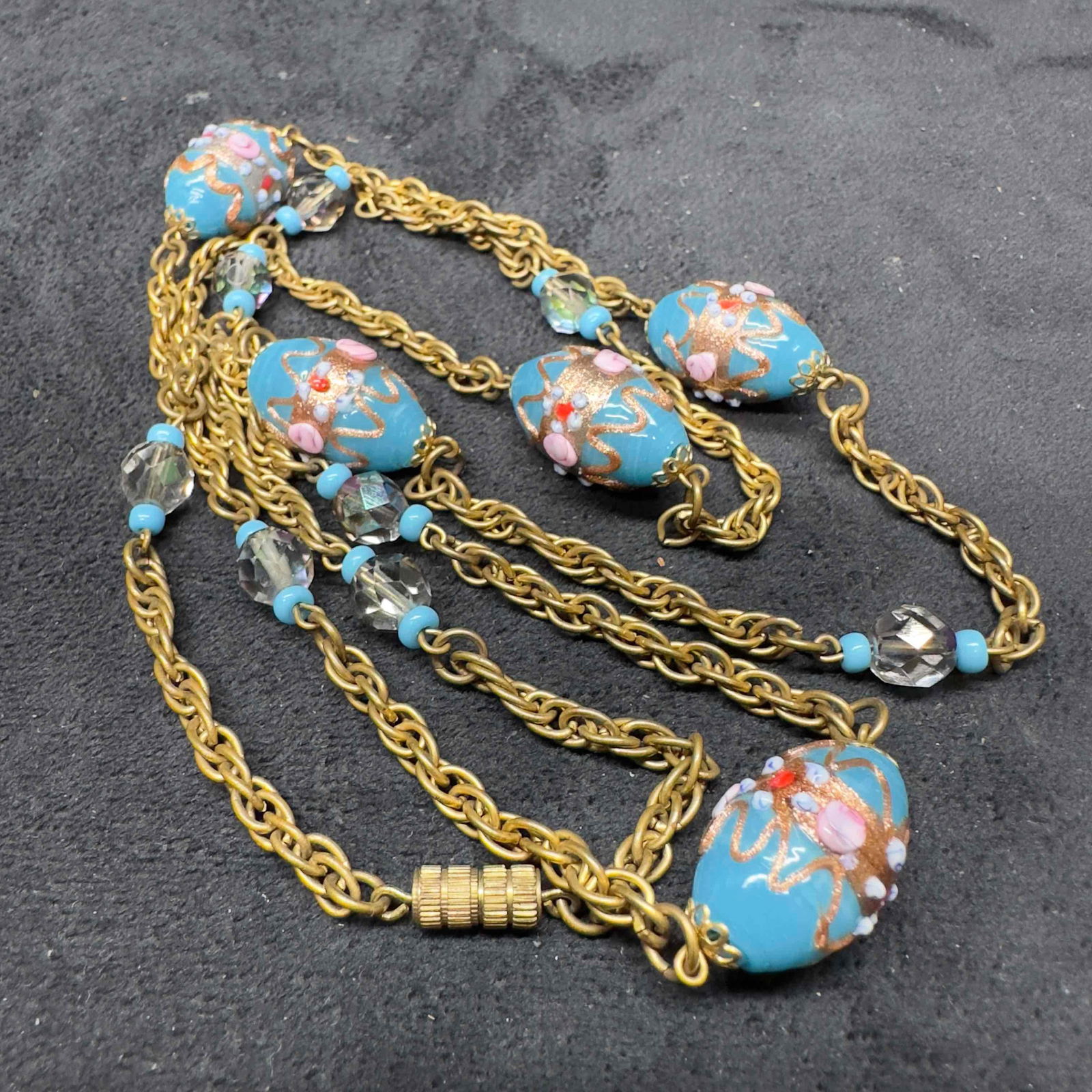 Murano Venetian Glass Lamp Work Blue Bead Fiorato Beaded Chain Necklace A61: Murano Venetian Glass Lamp Work Blue Bead Fiorato Beaded Chain Necklace A61. Necklace with blue colored glass beads with beautiful hand painted designs on each. The necklace features floral pink accen