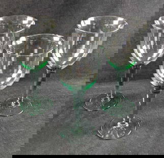Three Large Glass Water Goblets: Three Large Glass Water Goblets. All have a hint of green/teal color in the glass, mostly in the steams. The glasses are approx 4 1/8"x 4 1/8" x 9 1/2" and they all weigh together 1.67lb. The make and