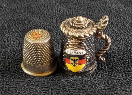 Sterling Silver Thimbles From Germany: Sterling Silver Thimbles From Germany These Thimbles are both sterling and from Germany. One is shaped like a beer stein and the other is a traditional thimble that has Germany engraved on it.  Weight