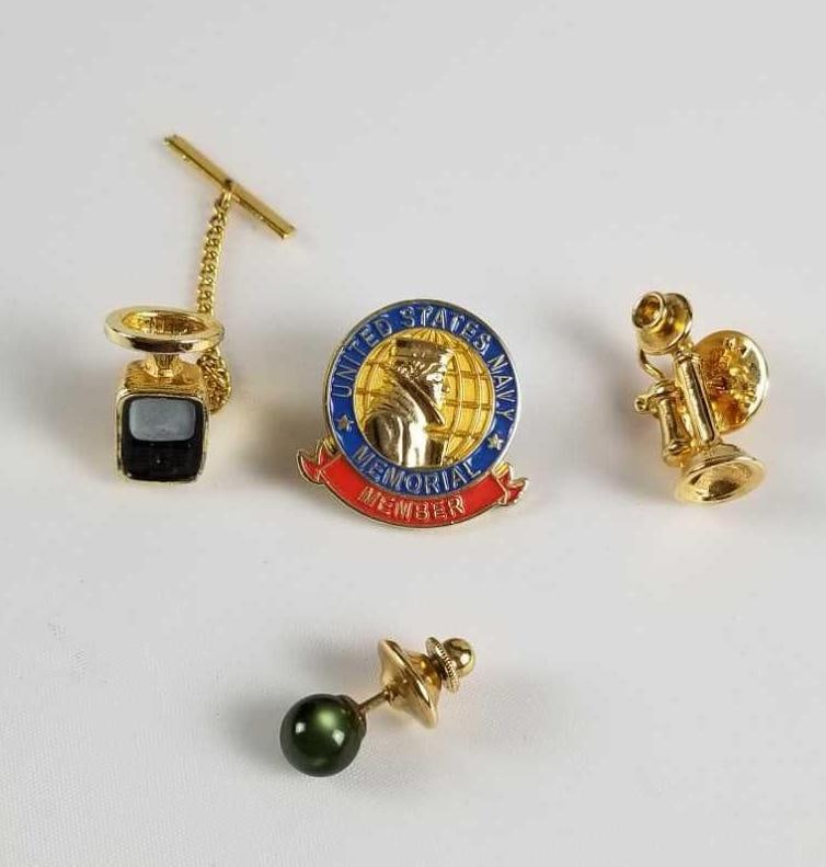 Assorted Pin and TieTac Lot of 4: This lot contains" 1- United States Navy Memorial Member Pin. Approx. measures 1" 1- Gold tone cell phone with halo tie tac. Approx. measures 3/4" 1- Gold tone telephone pin. Approx. measu