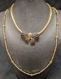 Vintage Vogue Trifari Gold Tone Enamel Bow Lot Of 2: Vintage Vogue Trifari Gold Tone Enamel Bow Lot Of 2. This lot includes:  (1) Trifari Gold Tone Snake Chain Enamel Bow Necklace. This is 2&#34; x 17 1/2&#34; x 1/4&#34;. (1) Vogue Gold Tone Bicone Neck