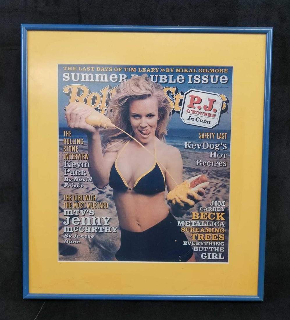 Framed Rolling Stone Jenny McCarthy Cover: Framed Rolling Stone Jenny McCarthy Cover. This framed Rolling Stone cover is in great used condition. The glass and frame both need to be cleaned. The cover has a yellow matte board and a blue colore