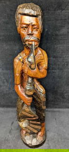 African Style Carved Wood Fisherman With Fishhook And Pipe Sculpture: African Style Carved Wood Fisherman With Fishhook And Pipe Sculpture. The man is either holding an giant fishhook or an odd shaped paddle. This is approx 6" x 5" x 25 1/2" and it weighs 5.50lbs. The s