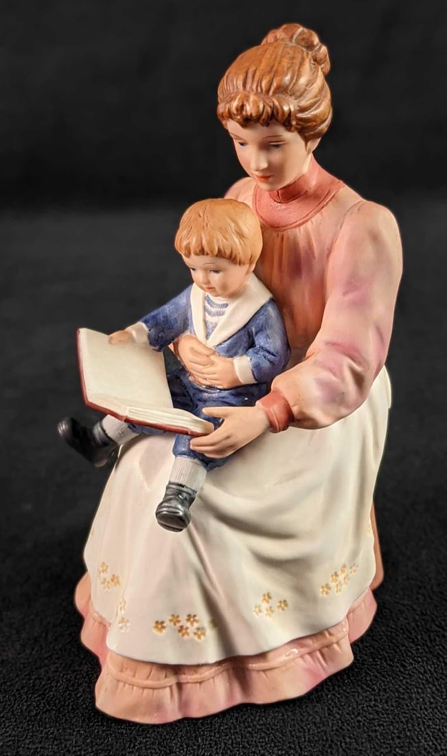 HOMCO Bisque Porcelain Storytime Figurine Mother With Child: Hand-painted bisque porcelain figurine of a mother reading a book to her child. By HOMCO. This is figurine #8858. The figurine is in a good, used conditon with light wear on the bottom and a few