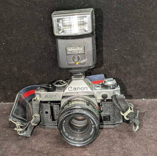 Vintage Canon AE-1 Program FD 35mm Film Camera With Minolta Flash: Vintage Canon AE-1 Program FD 35mm Film Camera With Minolta Flash. The camera is approx 31/2" x 6" x 3 3/4" and the Minolta Auto 25 flash is approx 4" x 2 1/4" x2 1/2". The total weight is 2.13lbs. Th