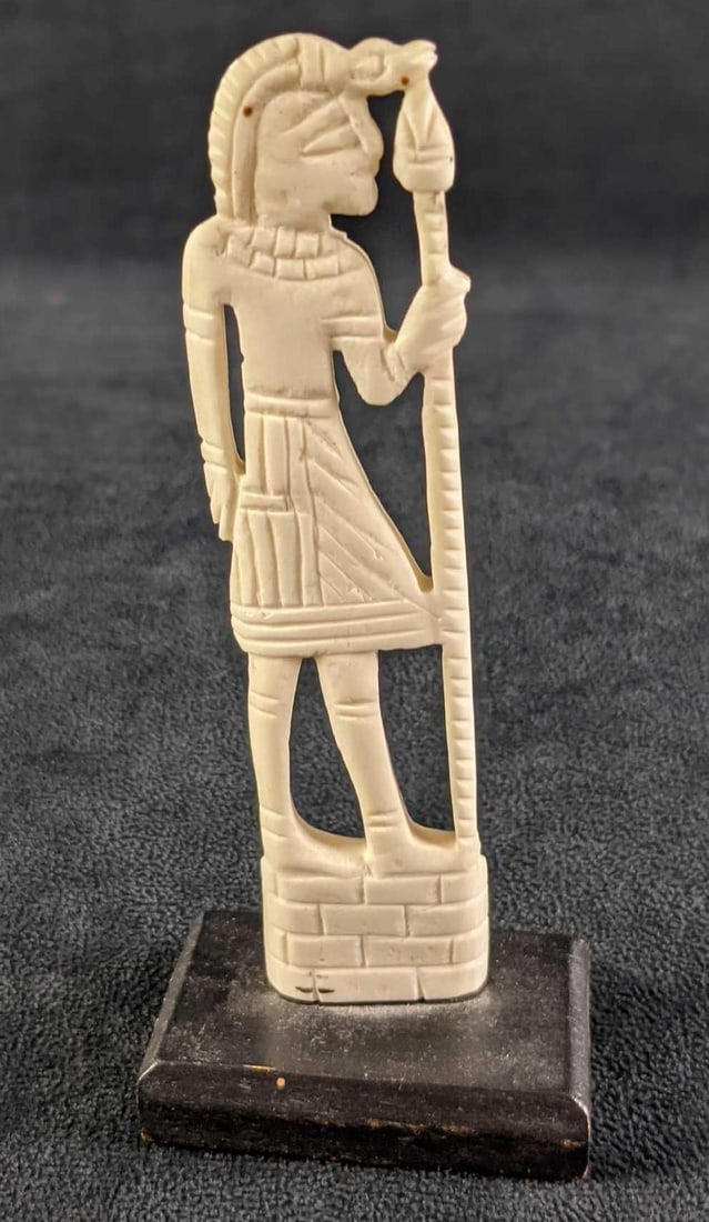 Natural Carved Bone Egyptian Hunter Figurine: Natural Carved Bone Egyptian Figurine On A Wood Base. Appears to be camel bone and of an Egyptian man with a spear. The maker or date of creation is unknown. Is approx 2 1/2" x 1 1/2" x 5 3/4". The fi