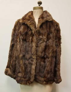 Brown Rabbit Fur Coat by Arnold Constable Fifth Avenue New York: This brown rabbit fur coat by Arnold Constable Fifth Ave New York is in good used condition with no damage to the exterior and with some light fading in color of the brown satin materiel from age and