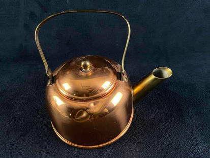 Small Copper Tea Kettle: Small Copper Tea Kettle  Copper tea kettle with brass spout and handle. In good condition with two dents on one side. The kettle was made by the Coppercraft Guild of Taunton Massachusetts.   Approxima