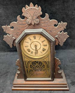 Antique E. Ingraham And Company Gingerbread Wood Clock: Antique E. Ingraham And Company Gingerbread Wood Clock. This is approx 14 1/2" x 4 3/4" x 19 3/4" and it weighs 5.90lbs. The clock is untested. It comes with both keys. The clock face has some marking