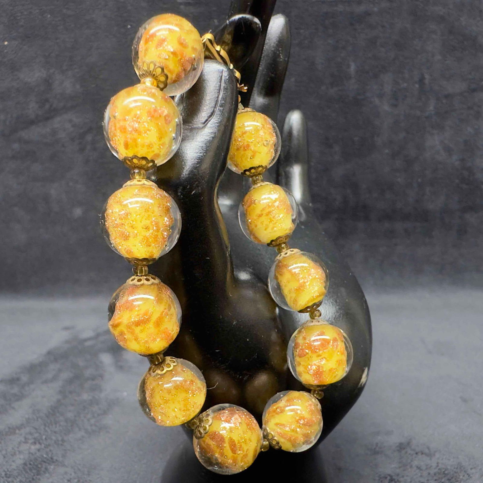 Murano Venetian Lamp Work Art Glass Yellow Copper Infused Accents Beaded Bracelet C14: Murano Venetian Lamp Work Art Glass Yellow Copper Infused Accents Beaded Bracelet C14. Bracelet with yellow colored glass beads with beautiful designs on each. The bracelet features copper accents. Th