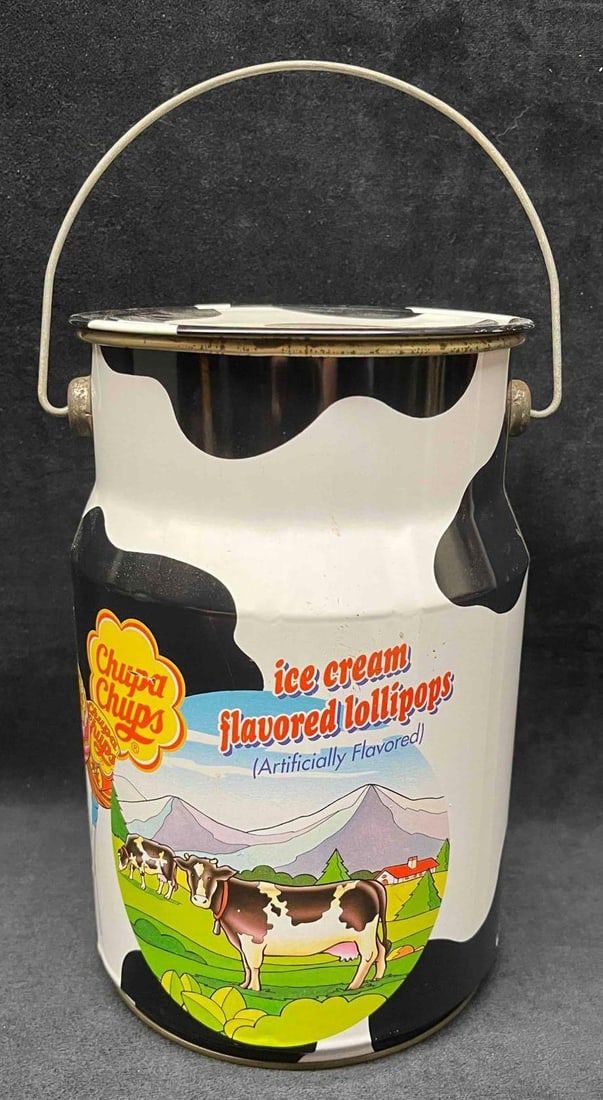 Vintage Chupa Chups Lollipops Cow Tin Second Edition: This lot contains a Vintage Chupa Chups Lollipops Cow Tin Second Edition. It is approx 6" x 6" x 91/2" and it weighs about 0.8lbs. Overall the tin is in good used condition with some light wear f